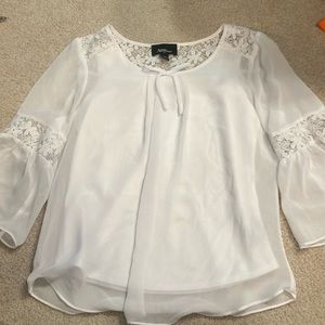 White blouse with lace on the arm sleeves in some places